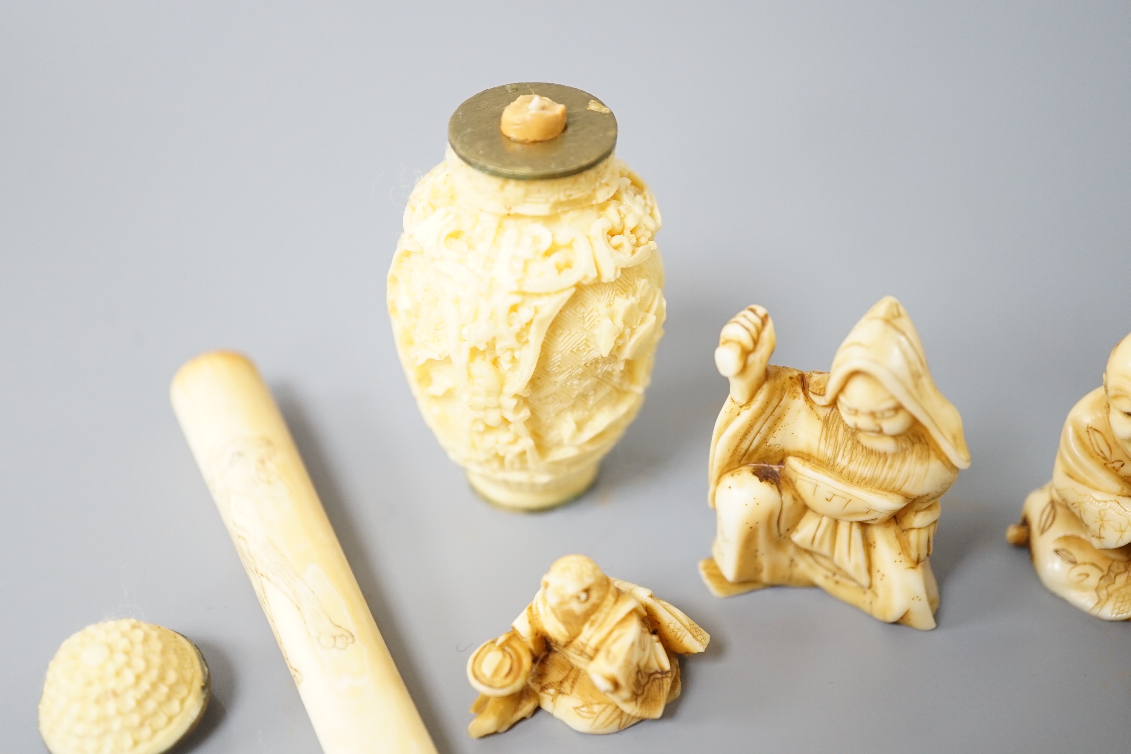 A group of Japanese ivory carvings including cheroot holder, snuff bottle, okimonos (5)